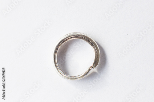 Handmade silver ring on white background.