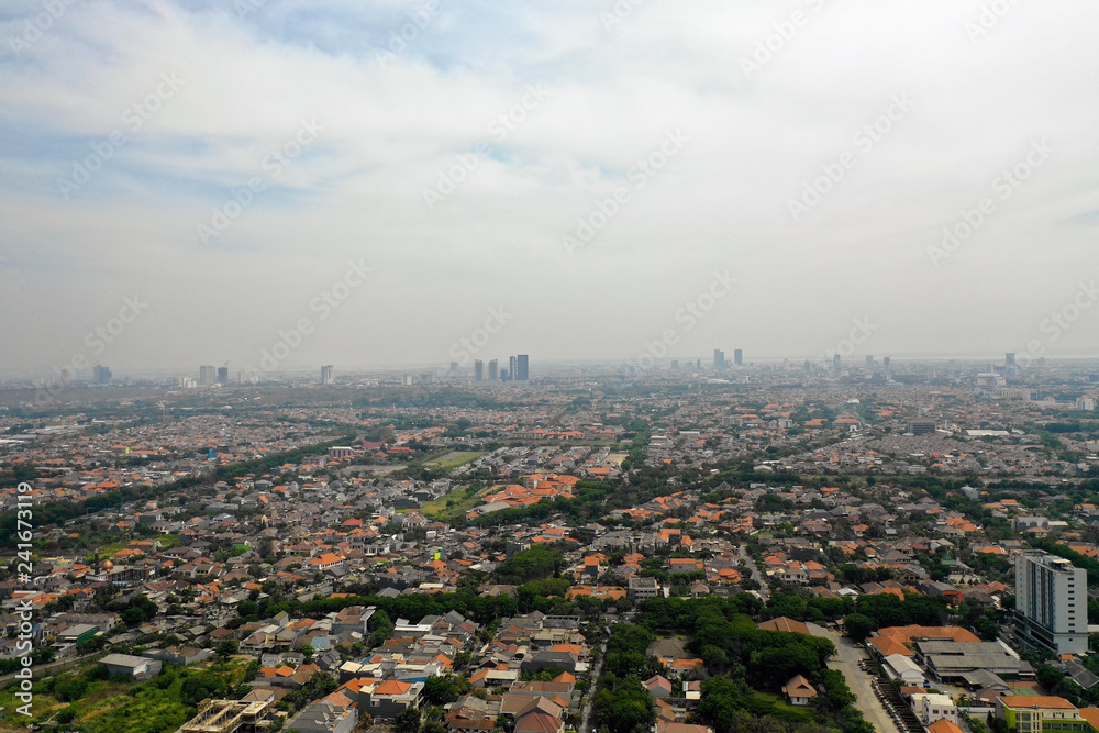 Fototapeta premium Aerial cityscape modern city Surabaya with skyscrapers, buildings and houses. city skyline with skyscrapers and business centers Surabaya capital city east java, indonesia