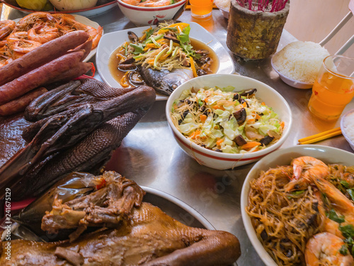 Food For pray Respect to predecessor in Chinese Culture and when Chinese new year Coming.Boiled Duck,Steamed Fish,Fried noodle with shrimp on the metal Table
