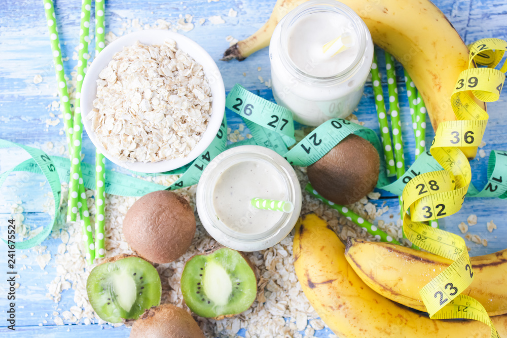 kiwi Banana smoothie with honey and oats on a wooden table. kiwi Banana smoothie with honey and oats on a wooden table.