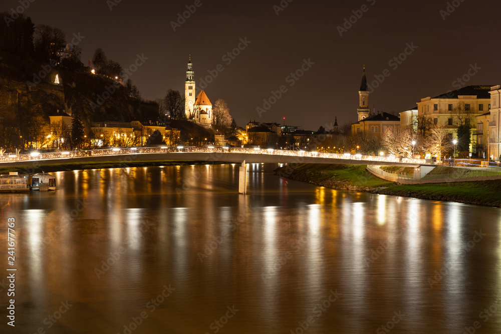 Bridge of love and Salzach river in Salzburg, Austria during night