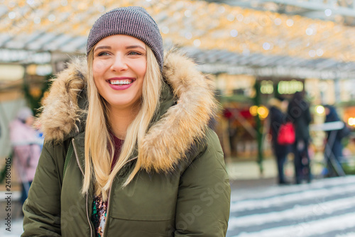 Portrait of attractive happy plus size young model in parka jacket casual style walk at city at winter day . Life of xl woman 