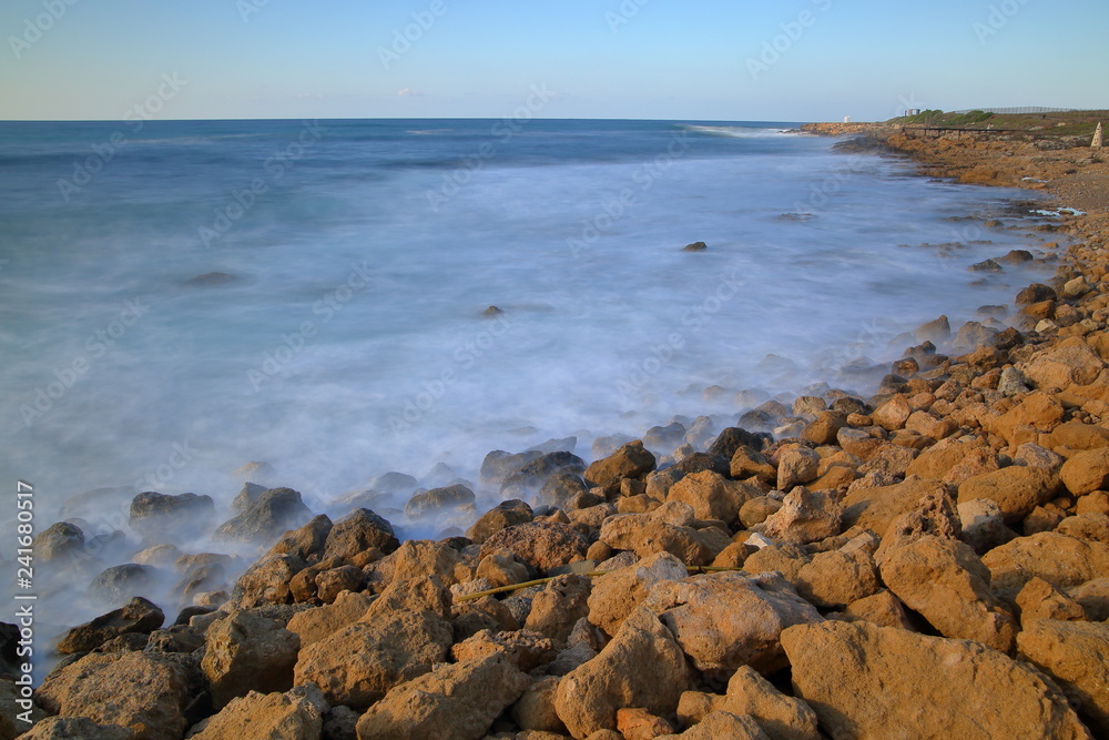 Seascape in Pafos, Cyprus, rocky, stony beach, Mediterranean Sea, horiozn, long exposure Seascape in Pafos, Cyprus, rocky, stony beach, Mediterranean Sea, horiozn, long exposure
