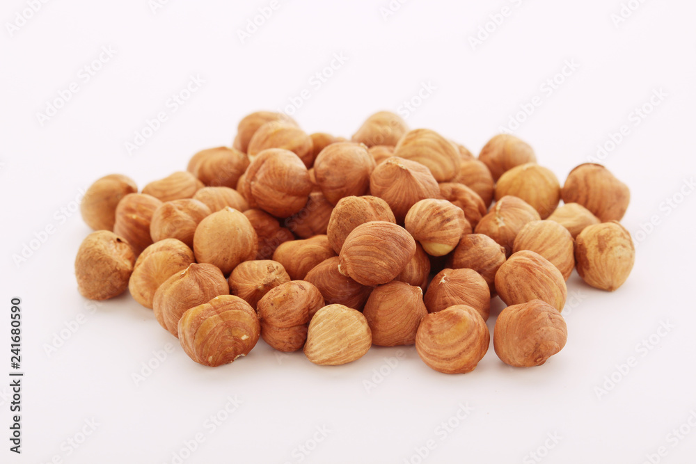 A pile of hazelnuts at white background A pile of hazelnuts at white background