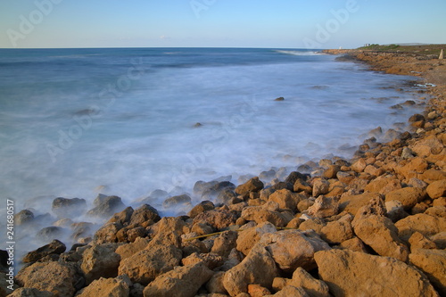 Fototapeta Naklejka Na Ścianę i Meble -  Seascape in Pafos, Cyprus, rocky, stony beach, Mediterranean Sea, horiozn, long exposure