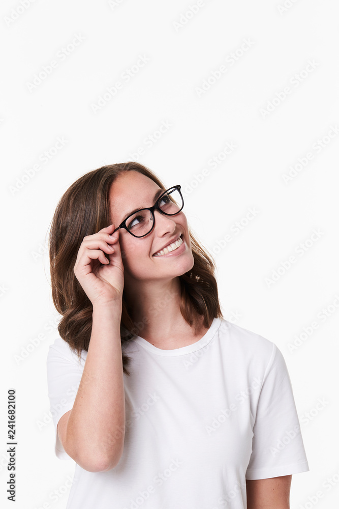 Smiling girl in glasses looking uyp, studio Smiling girl in glasses looking uyp, studio