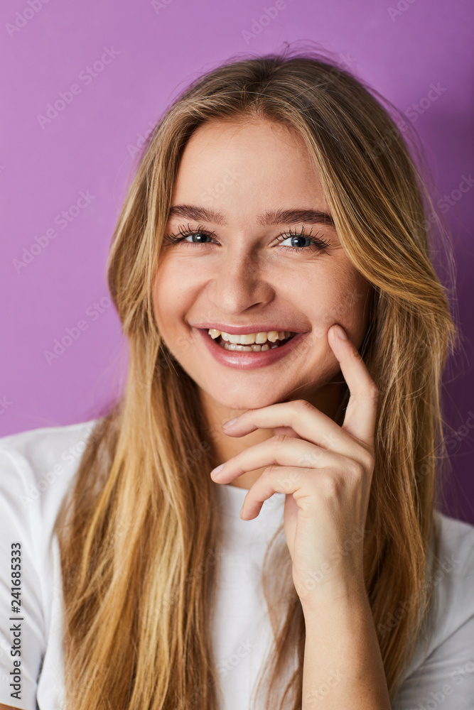 Smiling pretty girl against purple background