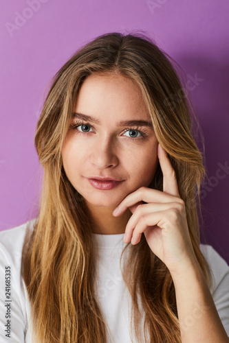 Young pretty girl against purple background