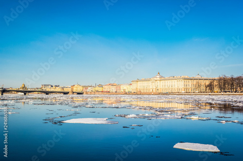 St. Petersburg granite embankment, panoramic view from Neva River on cityscape and architecture of city, spring ice drift, Saint Petersburg, Russia.