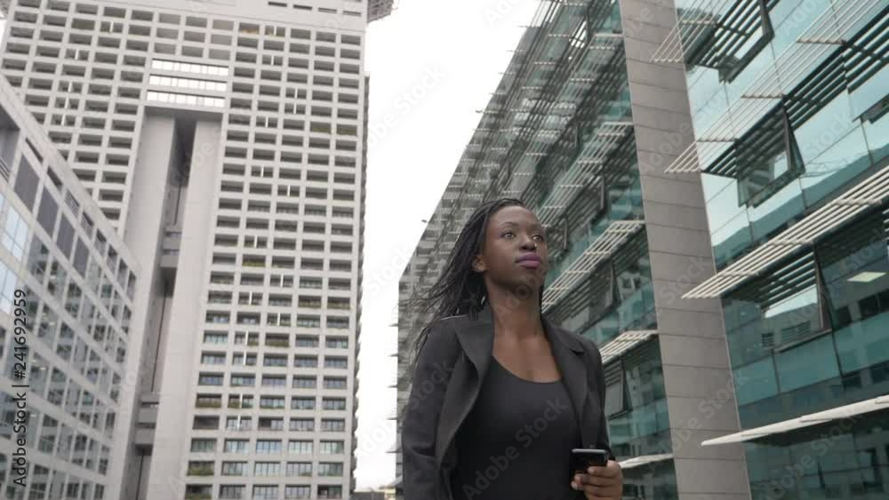 Attractive black american businesswoman walking in the city. Leadrship,success Attractive black american businesswoman walking in the city. Leadrship,success