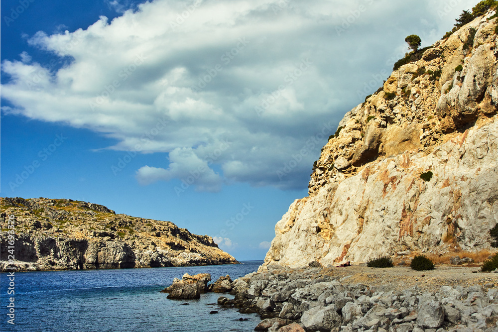 rocky cliff at the edge of the Mediterranean Sea, on the island of Rhodes..