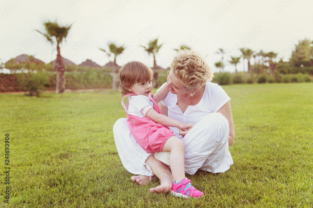mother and little daughter playing at backyard mother and little daughter playing at backyard