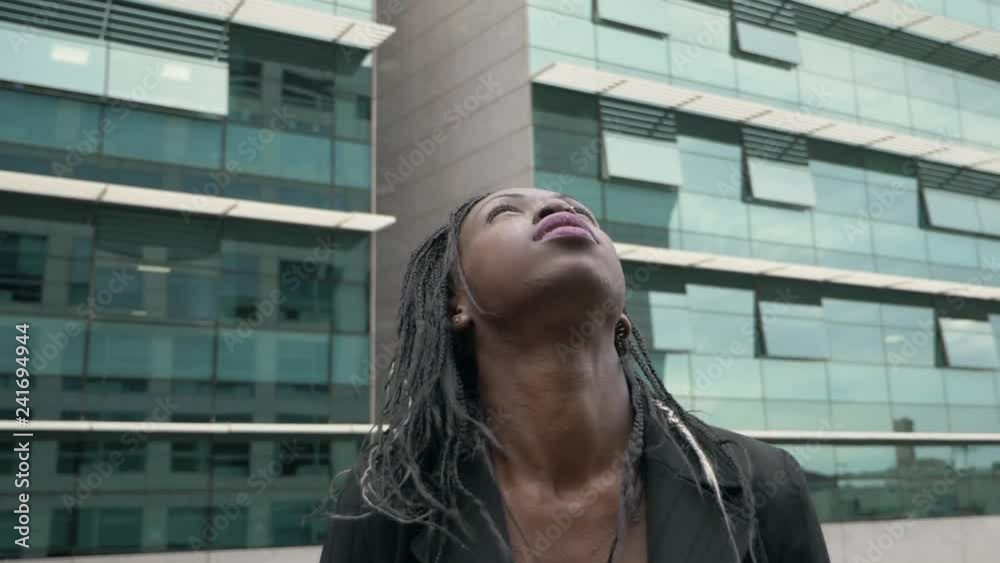 Beautiful black businesswoman looking up. Hope ,success - slow motion Beautiful black businesswoman looking up. Hope ,success - slow motion
