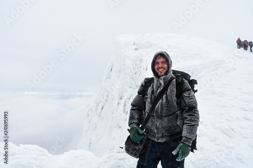 Hiker in a winter mountains. Concept of healthy lifestyle and successful climb, hiking in nature. Winter background