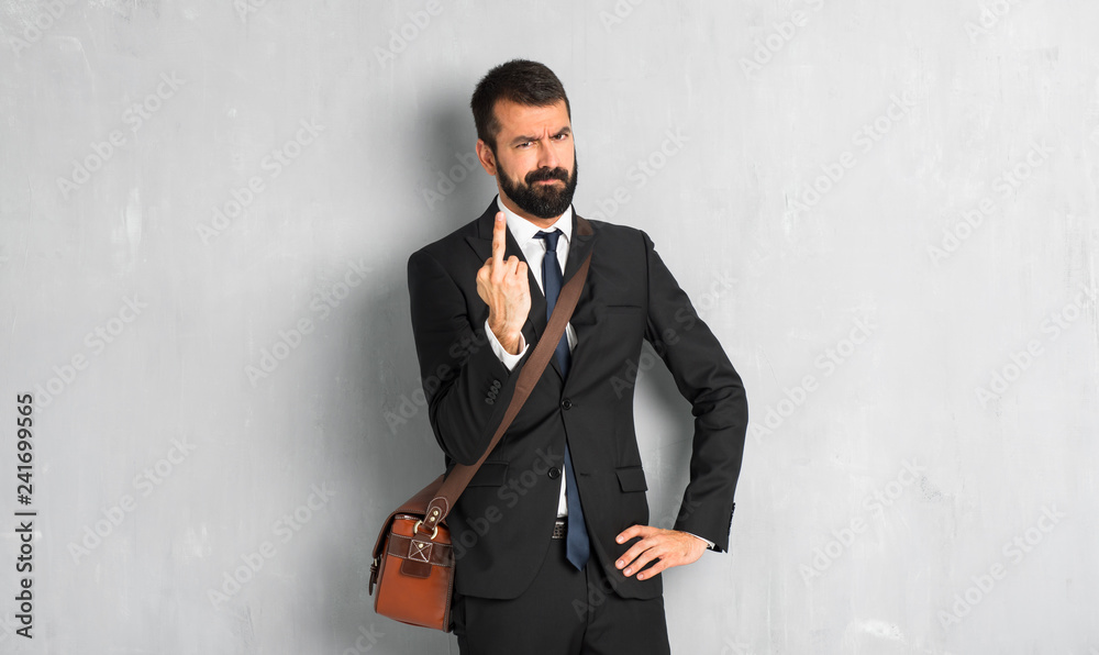 Businessman with beard making horn gesture Businessman with beard making horn gesture
