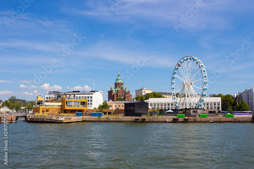 View of the embankment of the city of Helsinki, the Assumption Cathedral, the Ferris wheel and the Gulf of Finland on a summer day during a walk on the ferry.