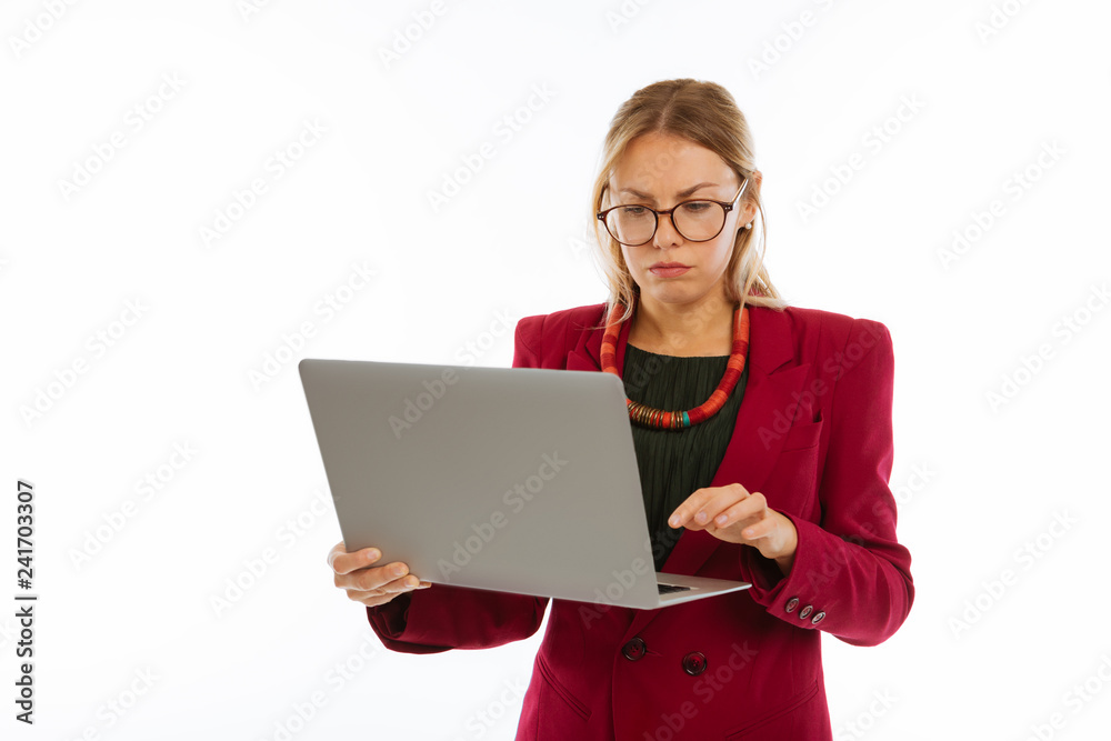 Pleasant smart woman pressing a button on the laptop Pleasant smart woman pressing a button on the laptop