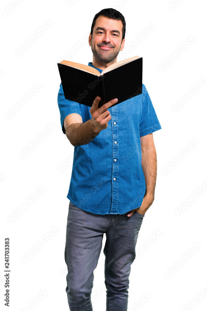 Handsome man with blue shirt reading a book Handsome man with blue shirt reading a book