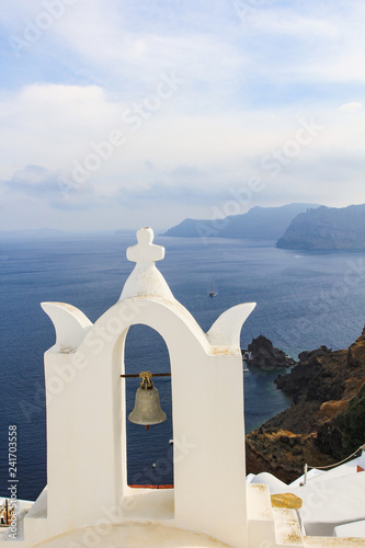 Greek orthodox church with small bell tower in Oia, Santorini island, Greece.