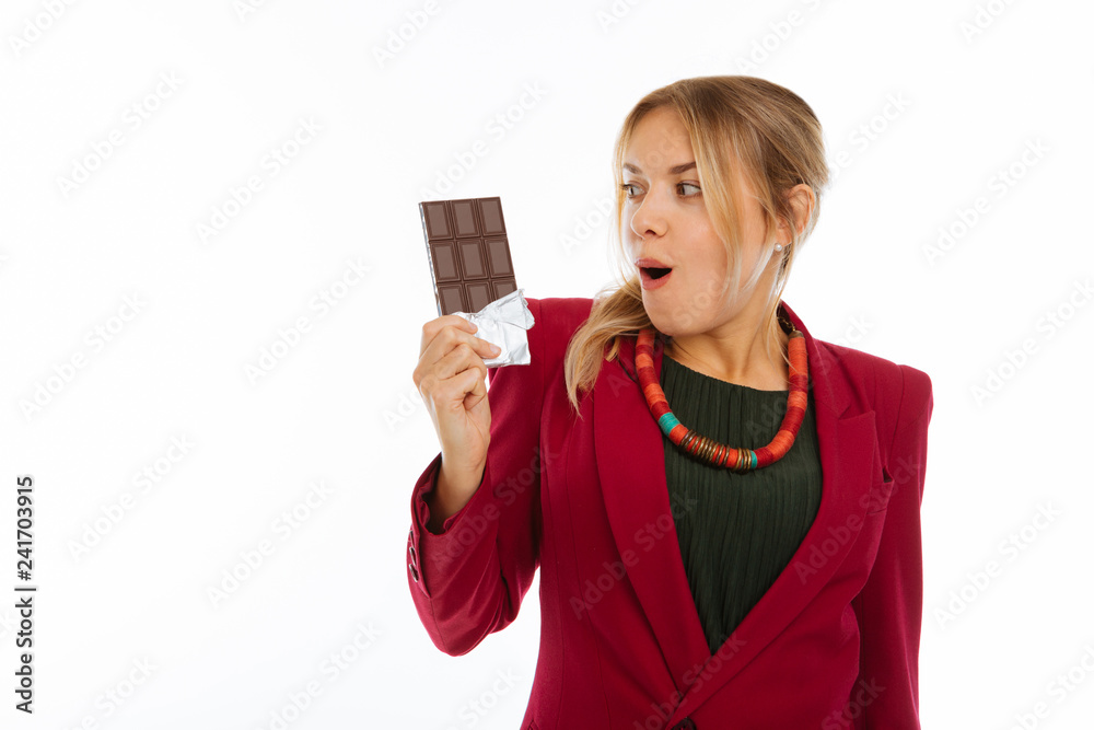 Nice happy excited woman looking at her chocolate Nice happy excited woman looking at her chocolate
