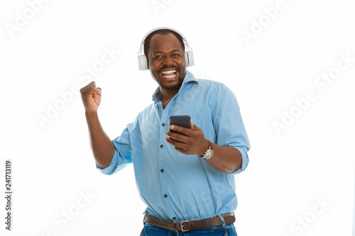 Delighted happy man holding his modern smartphone