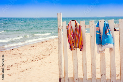 Fence with beach towels on the beach of Catania, Sicily, Italy.
