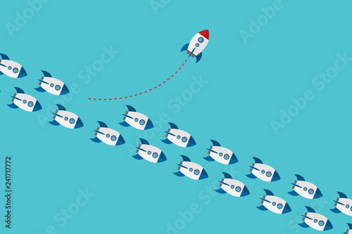  Think differently concept. Be different. Red rocket changing direction. New idea, change, trend, courage, creative solution, innovation and unique way concept.
