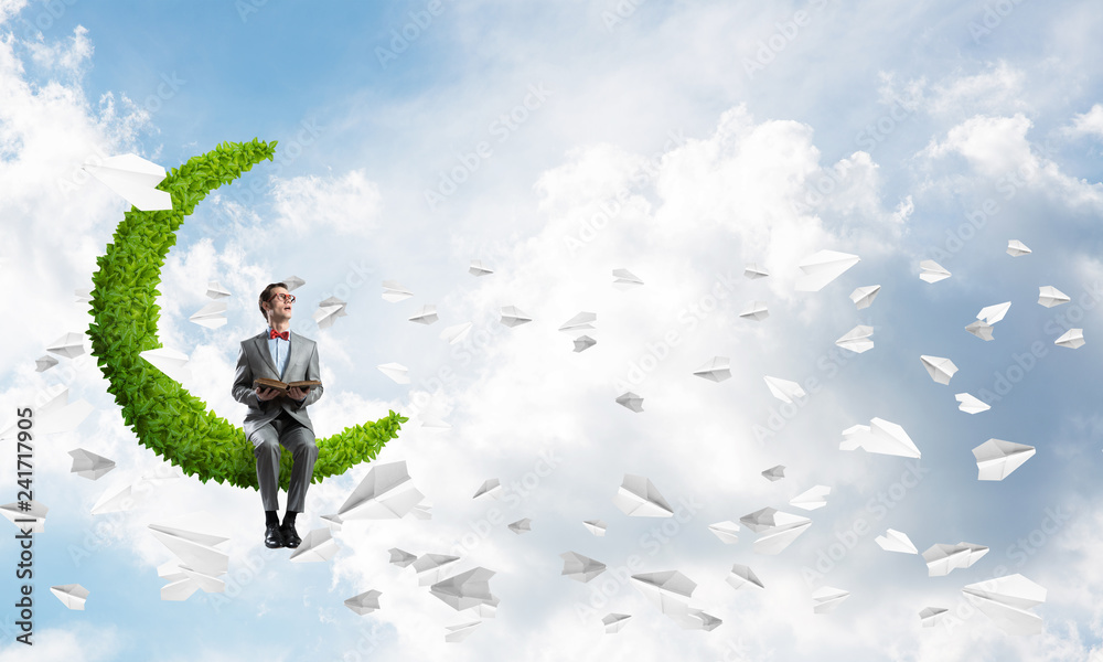 Young businessman or student studying the science and paper planes fly around Young businessman or student studying the science and paper planes fly around