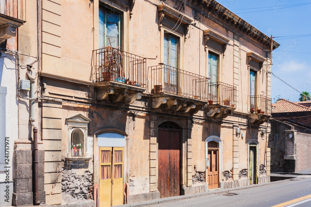 Travel to Italy -  historical street of Catania, Sicily, facade of ancient buildings.