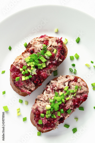 rye bread sandwiches with rabbit rillette and bog berry confiture decorated with chopped green onion