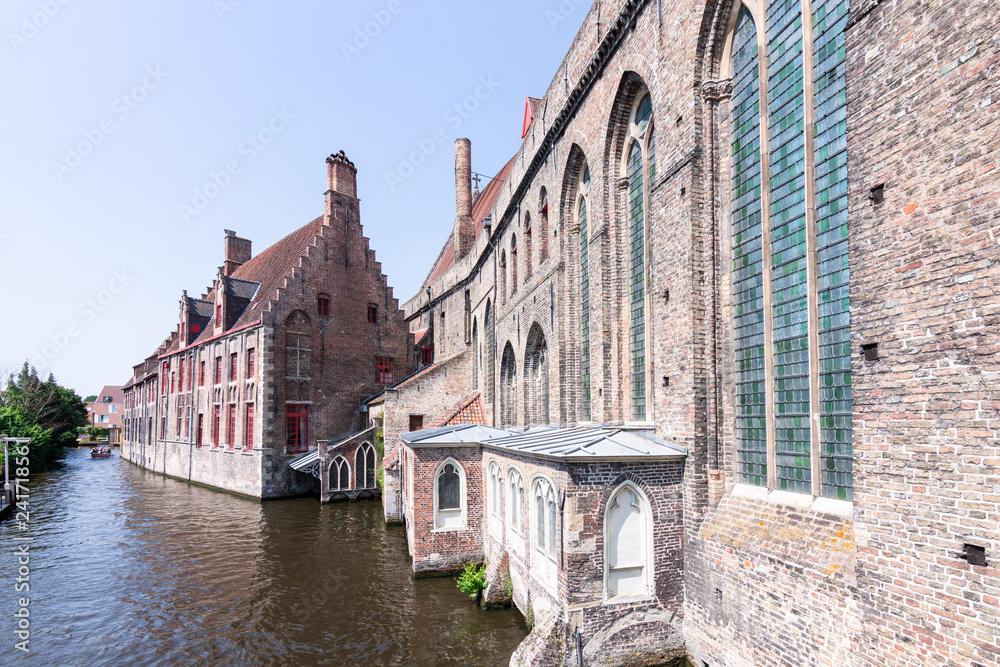 Historic buildings on the banks of the canals in Bruges, Belgium, Europe.