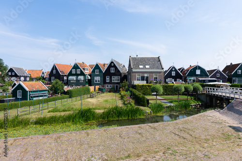 streets and houses of Marken, Netherlands, Europe. Green gardens and blue sky on a sunny day