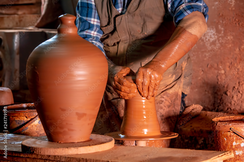 Professional potter making bowl in pottery workshop, studio. Professional potter making bowl in pottery workshop, studio.