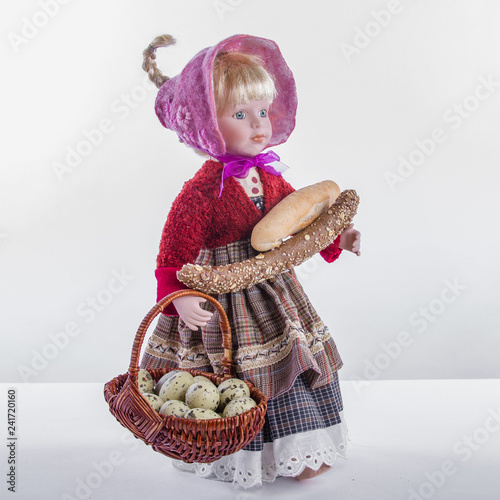 Cute goll in provincial costume, Easter holiday, health food. photo