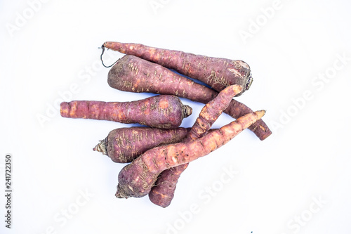 Close up of raw organic carrots or gajar or gaajar or Daucus carota  isolated on white. photo