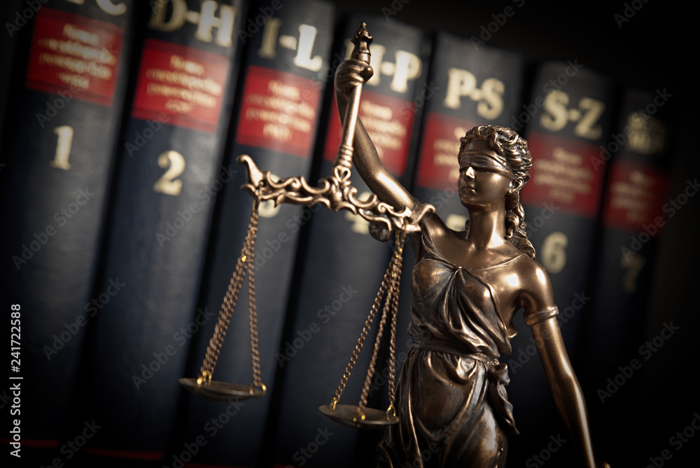 Fototapeta premium Statue of justice on books background