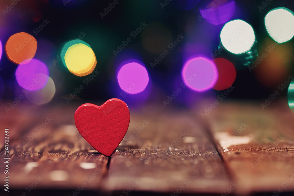 Red heart on the wood table and festive background with light spots and bokeh Red heart on the wood table and festive background with light spots and bokeh