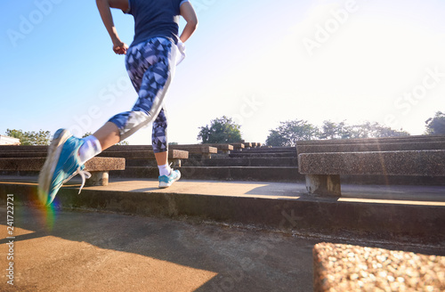 Low angle view of woman running on step