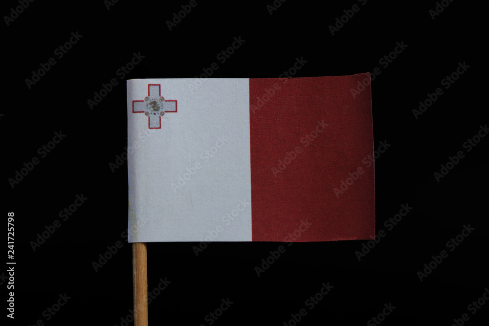 A beautiful and official flag of Malta on toothpick on black background.  Vertical bicolor of white