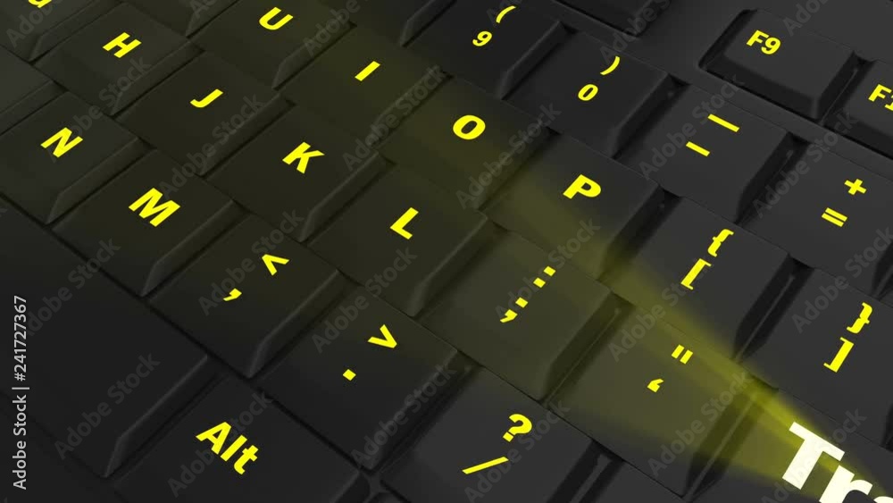 pointing the camera on yellow glowing Track key on black computer keyboard pointing the camera on yellow glowing Track key on black computer keyboard