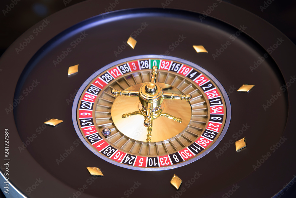 Gaming table, roulette wheel in motion Gaming table, roulette wheel in motion