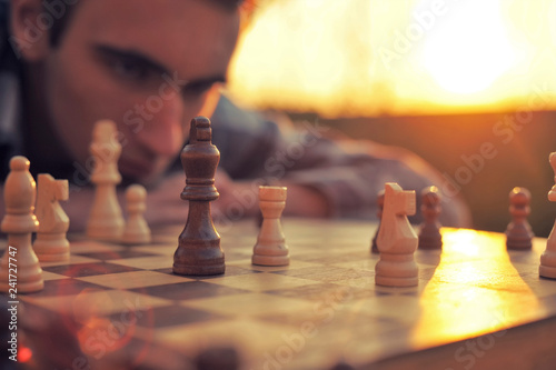 Man looks at a chessboard