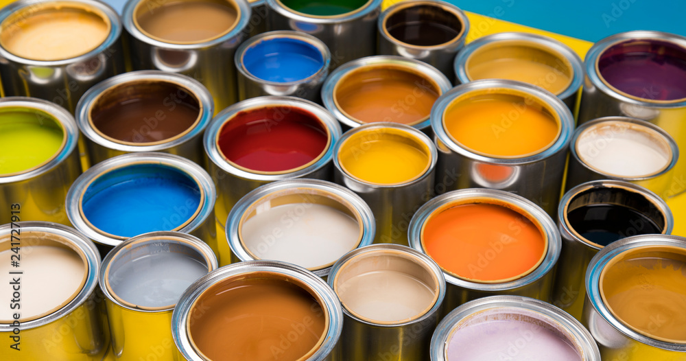 Full Buckets of rainbow colored oil paint on blue background Full Buckets of rainbow colored oil paint on blue background