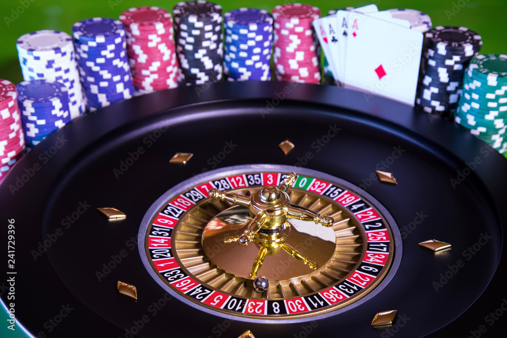 Poker Chips, Roulette wheel in motion, casino background Poker Chips, Roulette wheel in motion, casino background