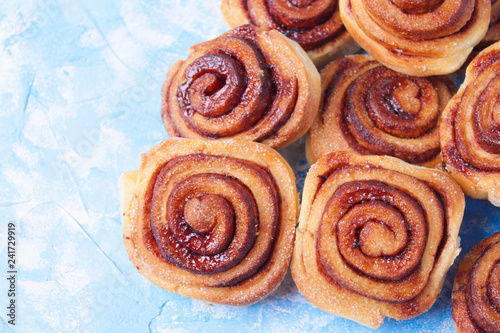cinnamon buns on the wooden background