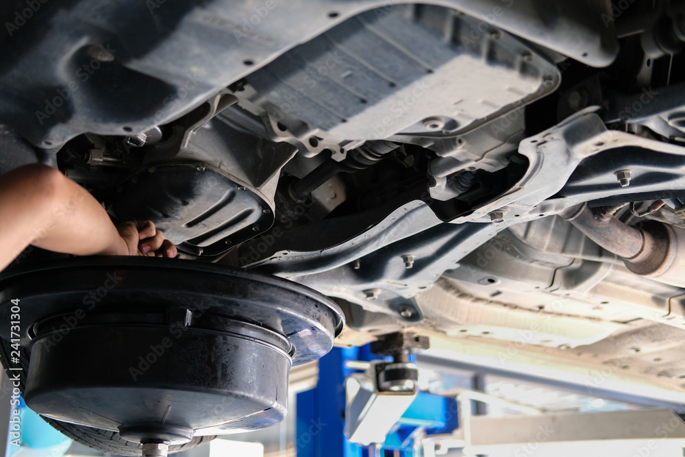 vehicle lift up by hydraulic for motor oil change & transmission inspection. changing engine oil in automobile repair service. maintenance & checkup in car workshop. vehicle lift up by hydraulic for motor oil change & transmission inspection. changing engine oil in automobile repair service. maintenance & checkup in car workshop.