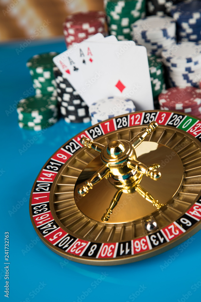 Poker Chips, Roulette wheel in motion, casino background Poker Chips, Roulette wheel in motion, casino background