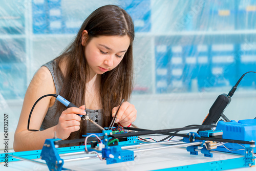 Schoolgirl in the classroom design and development of robots photo