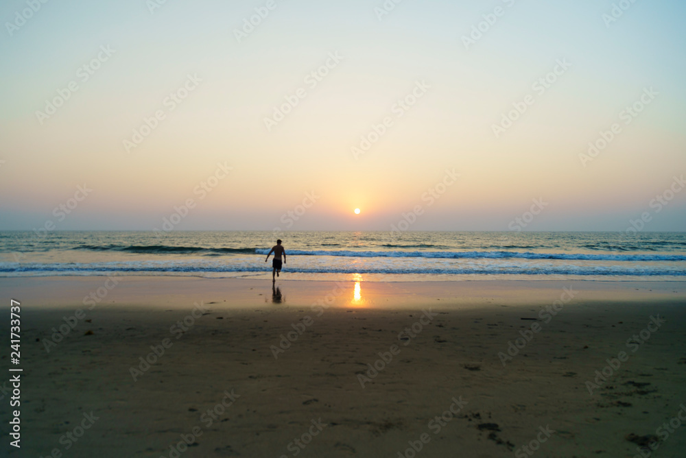 silhouette of a man on the beach at sunset