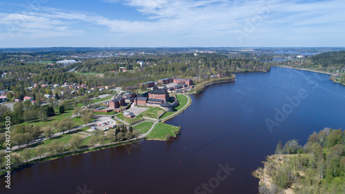 Beautiful city Hameenlinna at spring. View on castle and lake. Blue sky and clouds.  © raland